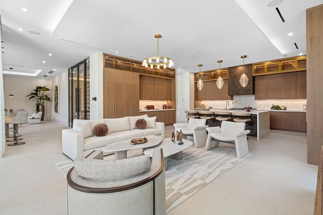 living area featuring a chandelier and recessed lighting