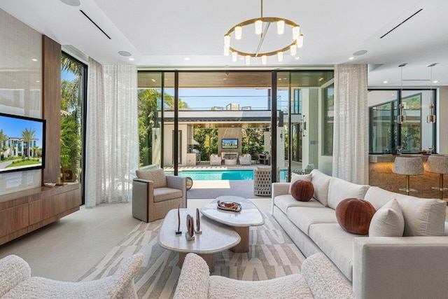 living area with expansive windows, plenty of natural light, and recessed lighting