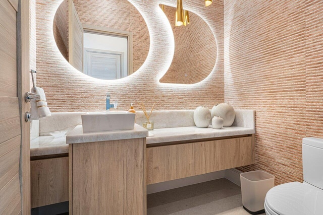 half bath featuring toilet and vanity