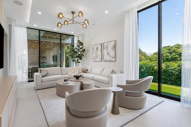 living room featuring floor to ceiling windows, a chandelier, and recessed lighting