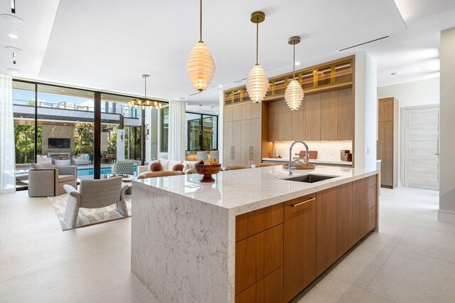 2498 Queen Palm Rd, Boca Raton, FL 33432 - kitchen featuring modern cabinets, open floor plan, a large island, floor to ceiling windows, and recessed lighting