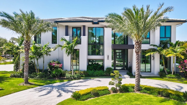 2498 Queen Palm Rd, Boca Raton, FL 33432 - modern home featuring stucco siding and curved driveway