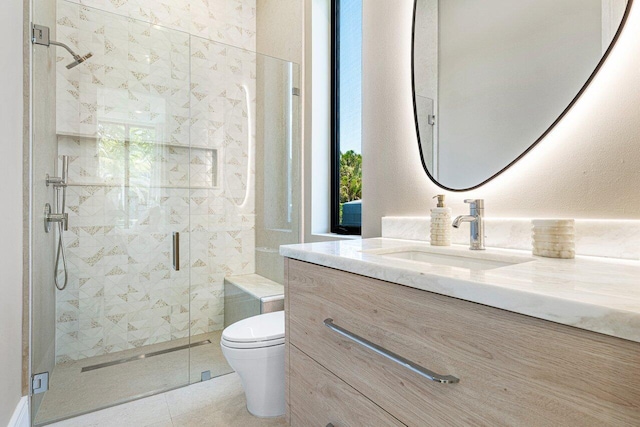 full bathroom with a stall shower, toilet, vanity, and healthy amount of natural light