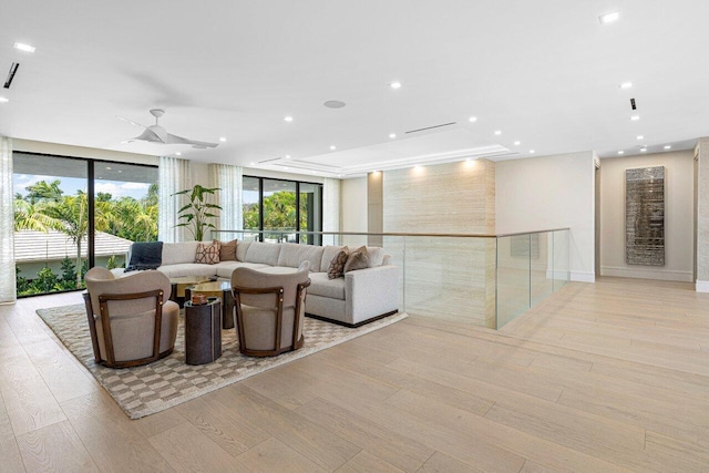 living room featuring light wood-type flooring, floor to ceiling windows, recessed lighting, and ceiling fan