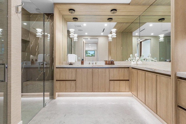 full bath with concrete floors, vanity, a stall shower, and recessed lighting