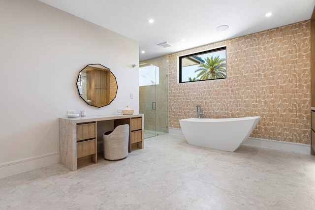 bathroom with a shower stall, vanity, a soaking tub, and recessed lighting