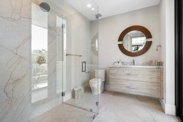 bathroom featuring a marble finish shower, vanity, marble finish floors, and toilet