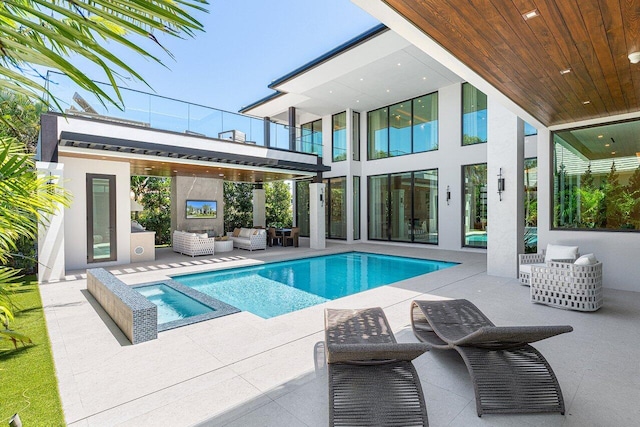 view of swimming pool featuring outdoor lounge area, a patio, and a pool with connected hot tub