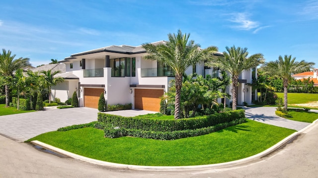 2498 Queen Palm Rd, Boca Raton, FL 33432 - contemporary home with stucco siding, a balcony, decorative driveway, and a garage