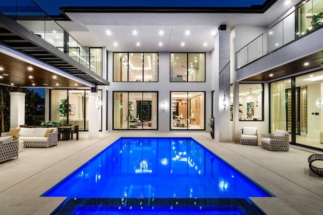 2498 Queen Palm Rd, Boca Raton, FL 33432 - rear view of property with an outdoor living space, a pool with connected hot tub, and a patio
