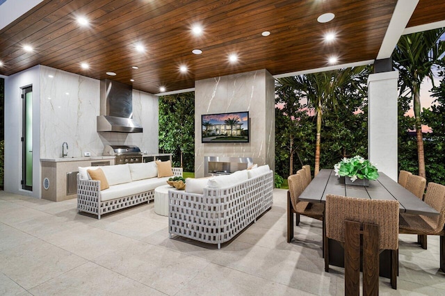 view of patio with area for grilling, outdoor dining area, an outdoor living space with a fireplace, and a sink