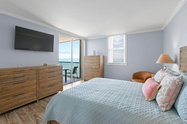 bedroom with multiple windows, access to outside, crown molding, and wood finished floors