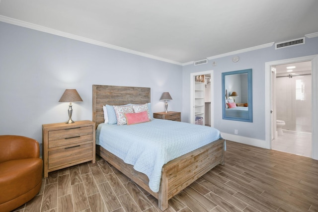 bedroom featuring wood finished floors, crown molding, baseboards, a spacious closet, and a closet