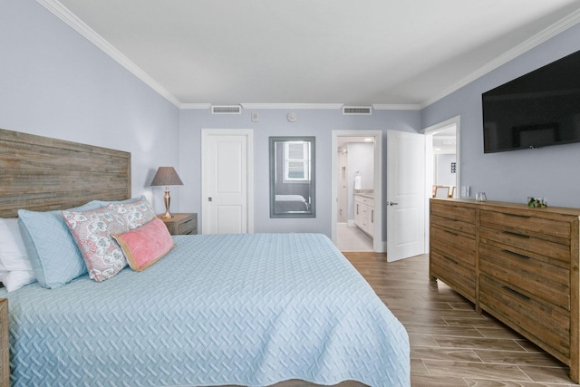 bedroom with wood finished floors, ornamental molding, and connected bathroom