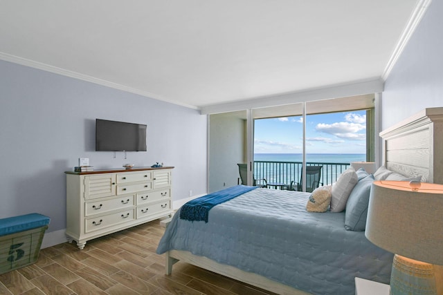 bedroom featuring ornamental molding, access to exterior, wood finished floors, baseboards, and floor to ceiling windows
