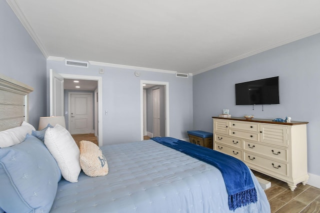 bedroom featuring crown molding, wood tiled floors, and baseboards