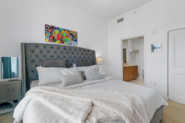 480 Hibiscus St Unit 1003, West Palm Beach, FL 33401 - bedroom featuring visible vents, light carpet, and ensuite bathroom