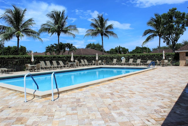9750 Tabebuia Tree Dr Unit A, Boynton Beach, FL 33436 - community pool with a patio and fence
