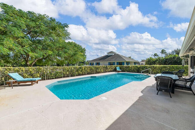 view of pool featuring a patio, a fenced in pool, and fence