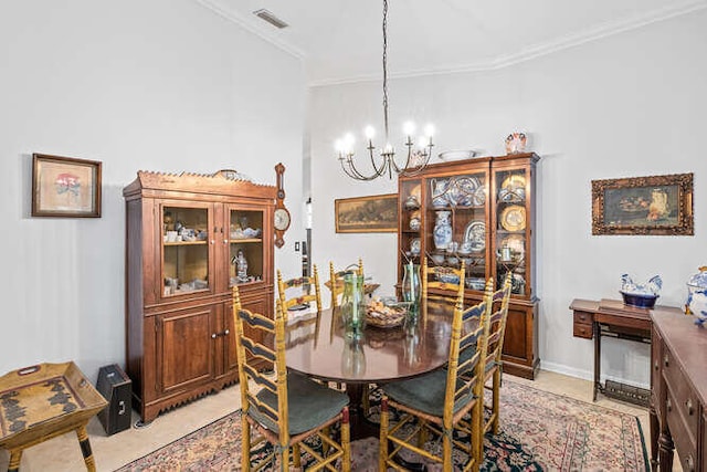 dining space with a chandelier, ornamental molding, light tile patterned floors, and a fireplace