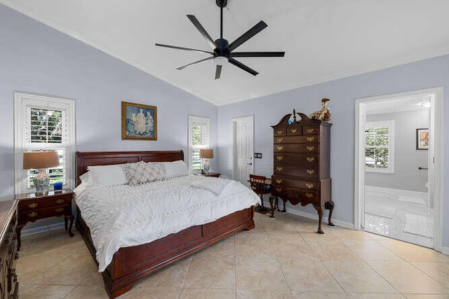 bedroom featuring light tile patterned flooring, ensuite bathroom, baseboards, a ceiling fan, and vaulted ceiling