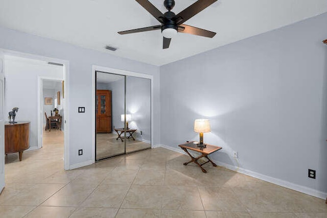 unfurnished bedroom with ceiling fan, visible vents, baseboards, a closet, and light tile patterned flooring