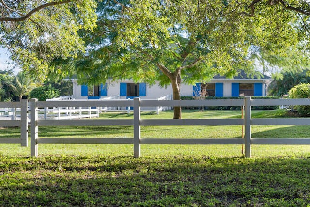 exterior space with a fenced front yard and a yard