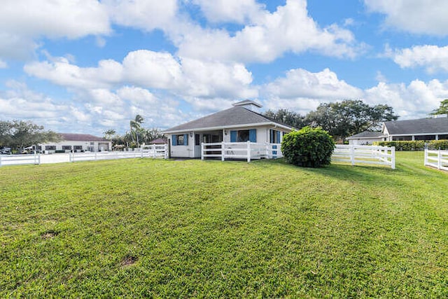 view of front of home with fence and a front yard