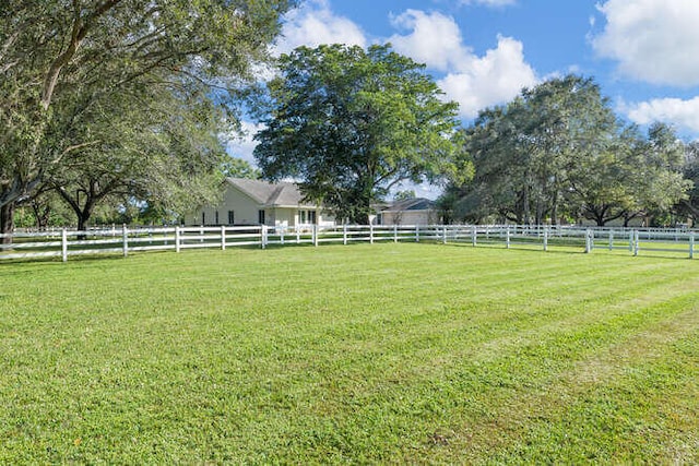 view of yard featuring a rural view and fence