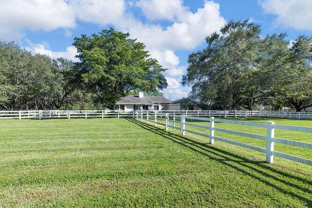 view of yard featuring fence and a rural view