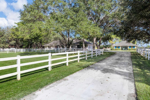 exterior space featuring fence and concrete driveway