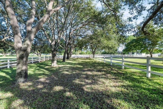 view of yard featuring fence and a rural view