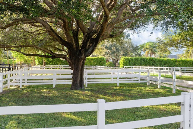 view of yard featuring a rural view and fence