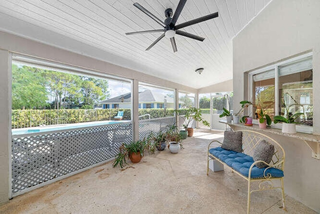 unfurnished sunroom featuring ceiling fan