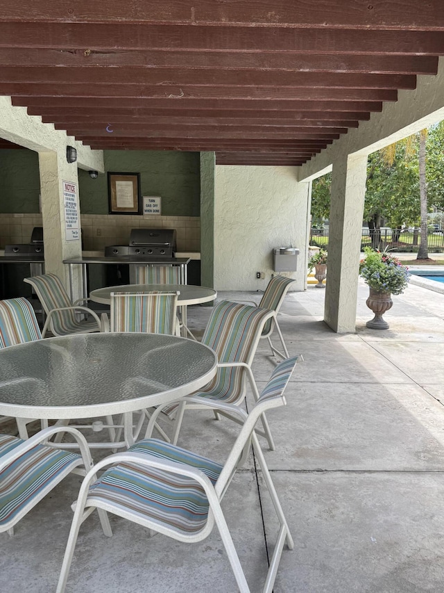 5155 E Sabal Palm Blvd Unit 101, Tamarac, FL 33319 - view of patio / terrace with grilling area, fence, and outdoor dining area