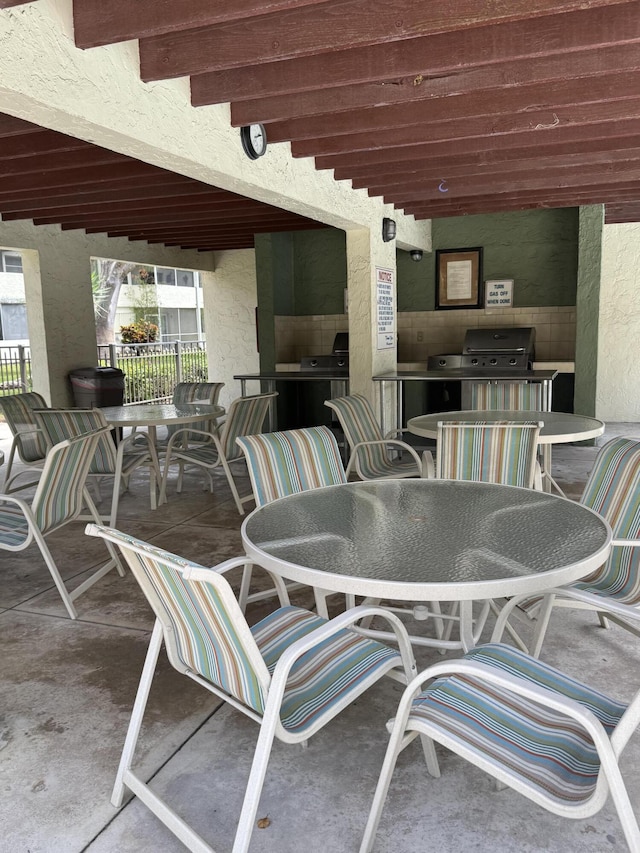 5155 E Sabal Palm Blvd Unit 101, Tamarac, FL 33319 - view of patio featuring grilling area, fence, and outdoor dining area