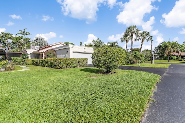 5674 Ainsley Ct, Boynton Beach, FL 33437 - view of home's exterior featuring a yard, a garage, and stucco siding