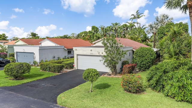 5674 Ainsley Ct, Boynton Beach, FL 33437 - view of front of property featuring an attached garage, a front lawn, driveway, stucco siding, and a tiled roof