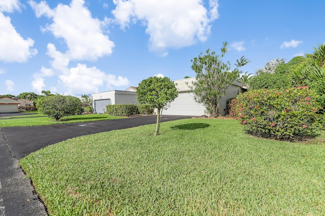 5674 Ainsley Ct, Boynton Beach, FL 33437 - view of front facade featuring driveway, a front lawn, an attached garage, and stucco siding