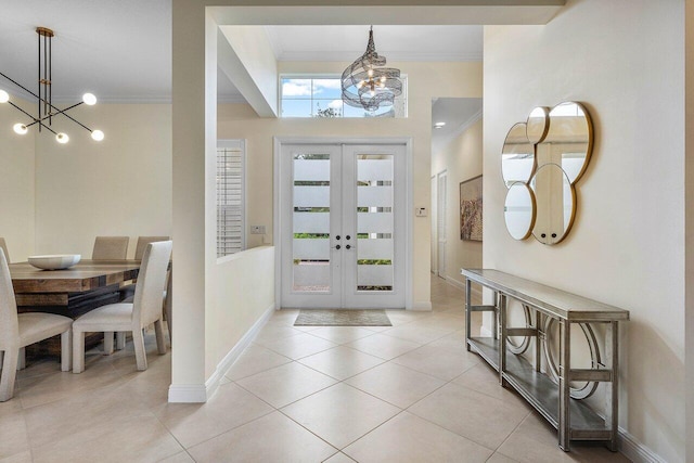 11952 Fox Hill Cir, Boynton Beach, FL 33473 - foyer entrance featuring a chandelier, crown molding, french doors, baseboards, and light tile patterned flooring
