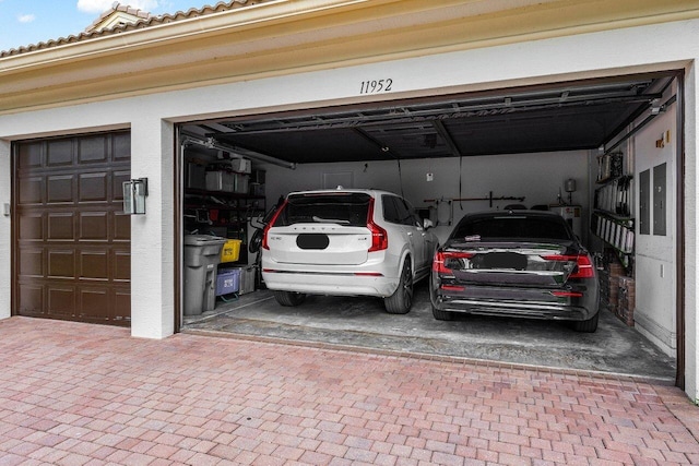 11952 Fox Hill Cir, Boynton Beach, FL 33473 - garage with decorative driveway and electric panel