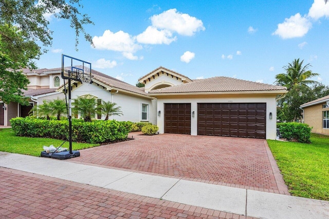 11952 Fox Hill Cir, Boynton Beach, FL 33473 - mediterranean / spanish home with decorative driveway, an attached garage, stucco siding, a front yard, and a tile roof