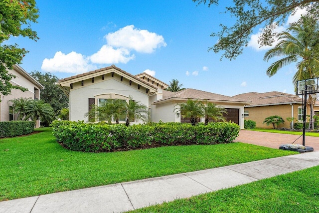 11952 Fox Hill Cir, Boynton Beach, FL 33473 - mediterranean / spanish-style home featuring decorative driveway, stucco siding, a front yard, a garage, and a tiled roof