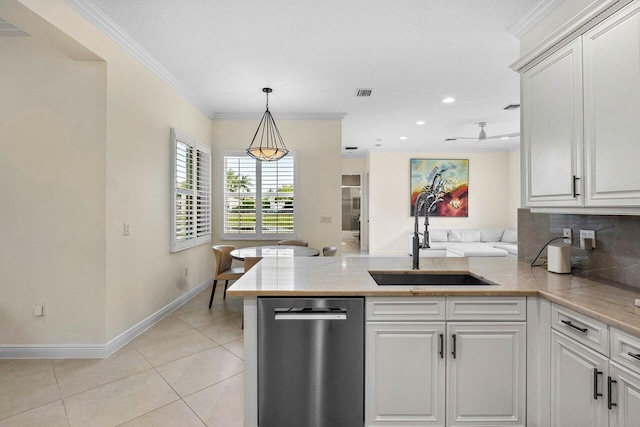 11952 Fox Hill Cir, Boynton Beach, FL 33473 - kitchen with stainless steel dishwasher, a sink, a peninsula, hanging light fixtures, and white cabinetry