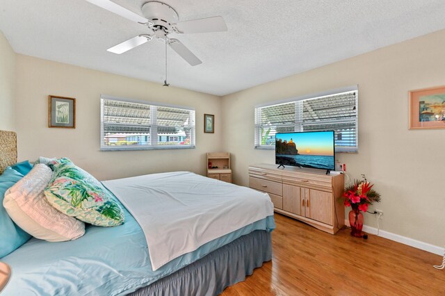 bedroom featuring baseboards, ceiling fan, and light wood finished floors