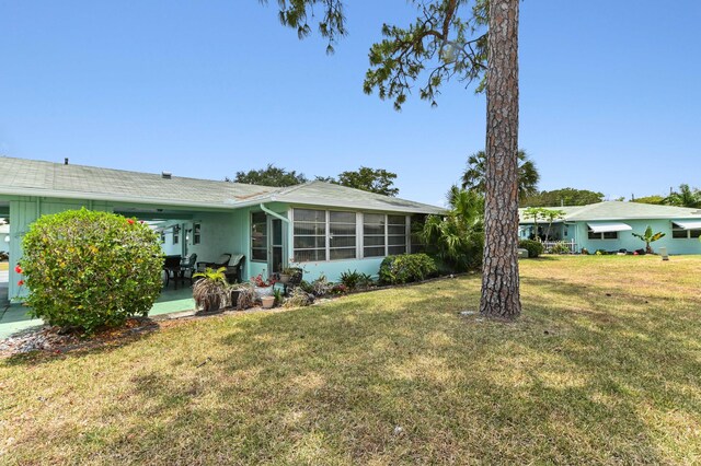 view of yard featuring a patio area and a sunroom