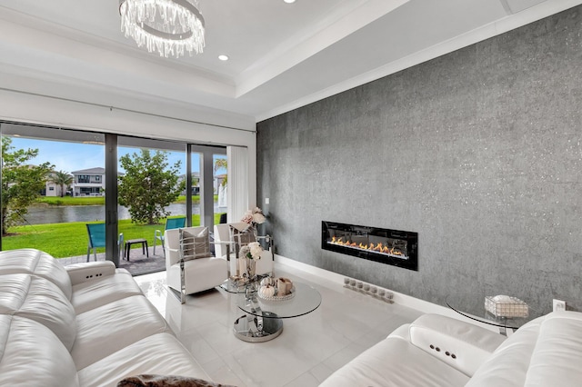 living area featuring a water view, tile patterned flooring, a glass covered fireplace, a chandelier, and recessed lighting