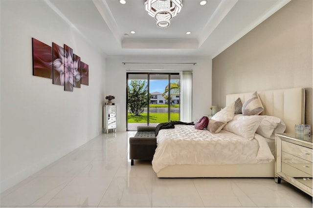 bedroom with marble finish floor, access to outside, a tray ceiling, and recessed lighting