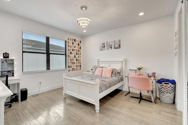 bedroom with baseboards, a notable chandelier, recessed lighting, and wood finished floors