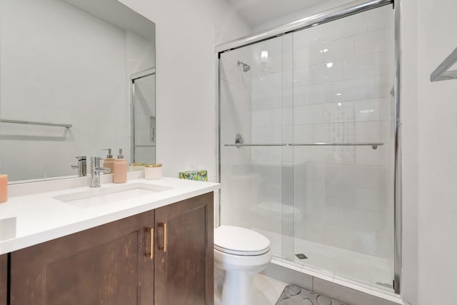 full bath featuring vanity, toilet, and a shower stall